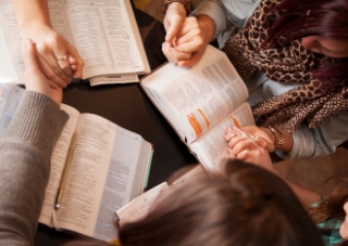 group holding hands bible study